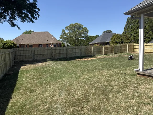 Wood privacy fence behind a landscaped garden bed