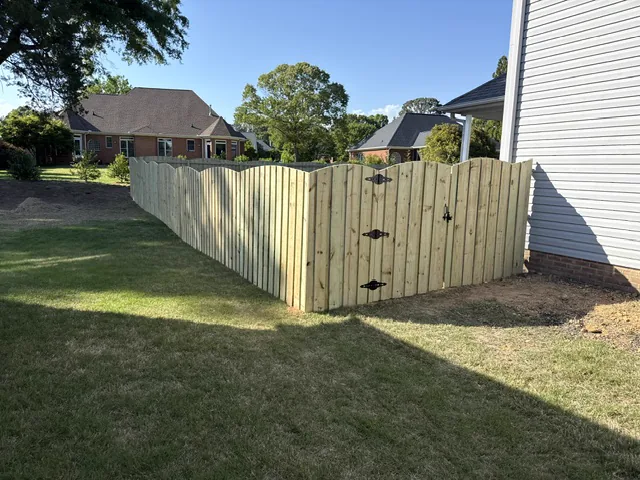 Scalloped-top wood fence with a matching gate